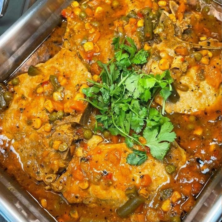 Pollo guisado — stewed chicken simmered in sofrito with peppers and cilantro